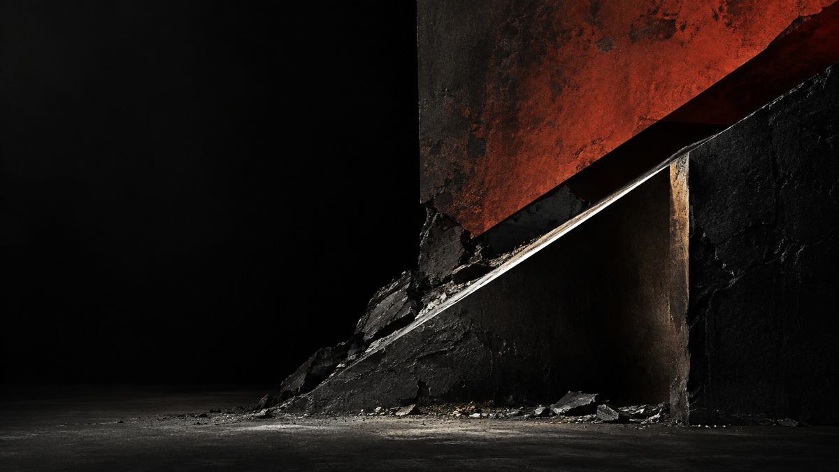 Abstract black and oxide-red material planes separated by a diagonal cut